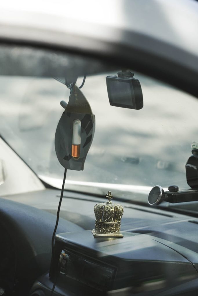 Close-up view of car interior featuring dashboard decor and gadgetry.