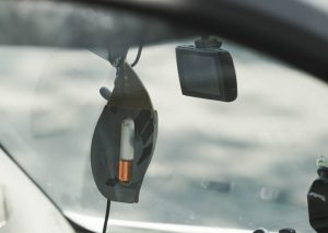 Close-up view of car interior featuring dashboard decor and gadgetry.